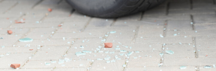 Automobile tyre and pieces of broken glass, car break in, traces of crime, car accident - obrazy, fototapety, plakaty