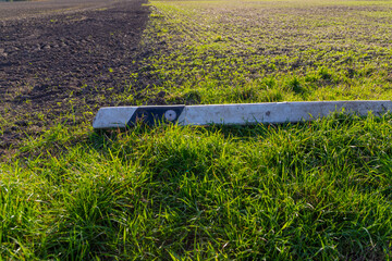 demolished delineator post on a field