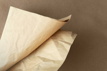 Creased Craft light brown color recyclable organic folded paper bag texture on solid brown background