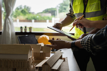 Architect man working with blueprints for architectural plan, engineer sketching a construction project concept