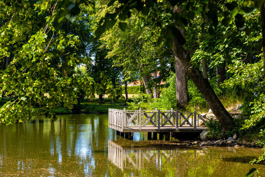 Historic park of XVI century Rozalin Palace with vintage trees and ponds during summer season in Rozalin village in Mazovia region of Poland