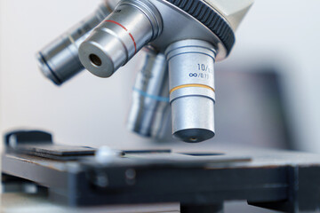 Fototapeta na wymiar Close-up shot of microscope with metal lens at laboratory.