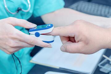  Doctor checking oxygenation with fingertip pulse oximeter. Saturation blood of oxygen. Measuring...