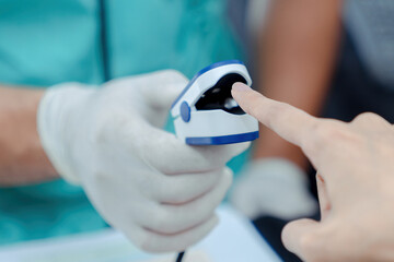  Doctor checking oxygenation with fingertip pulse oximeter. Saturation blood of oxygen. Measuring...