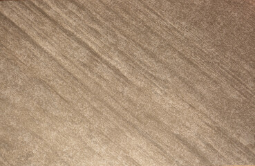 Brown background from decorative plaster with abstract spots. Unusual beige wall texture with beautiful patterns, creative surface background. Front covering for facing of buildings.