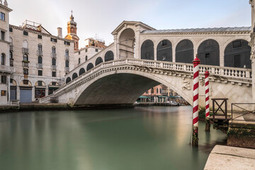 Fototapeta na wymiar Panorama of Grand Canal and Rialto Bridge in the Morning, Venice, Italy. Long exposure to smooth the water of the canal