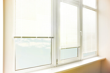 Fototapeta na wymiar Stylish window with horizontal blinds in room