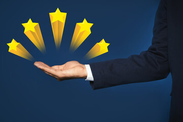 Man showing icons of five stars on blue background, closeup. Quality rating