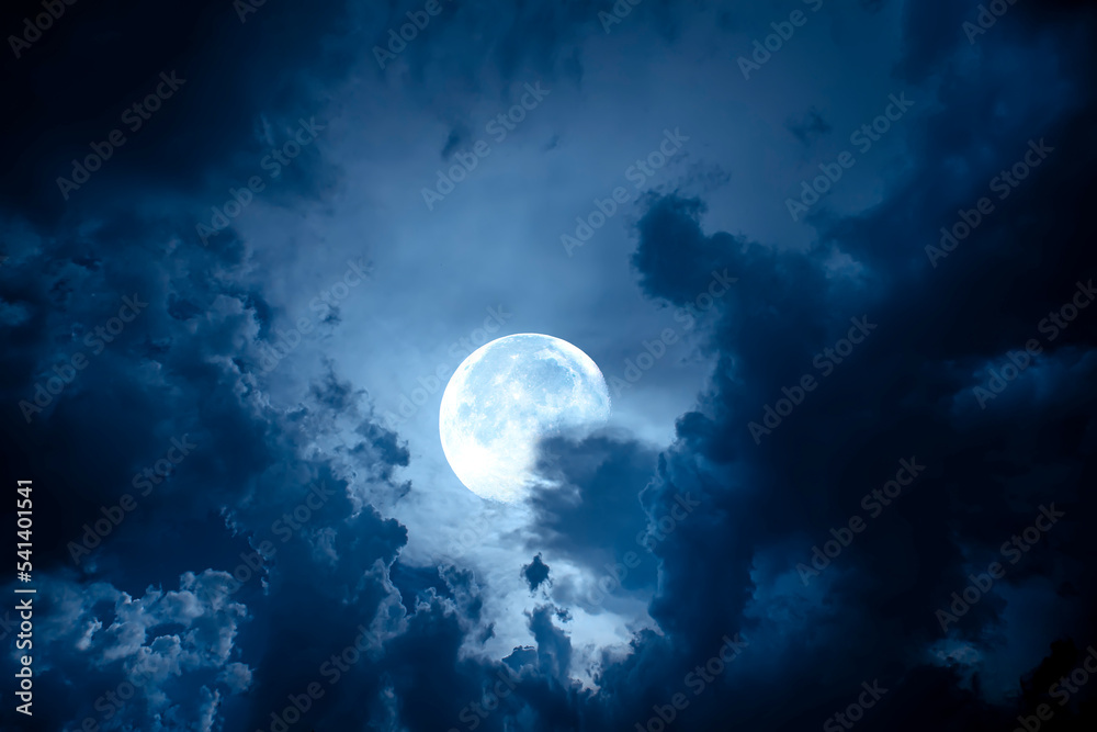 Wall mural night sky with full moon. dramatic clouds in mystic moonlight. large bright moon as concept of myste