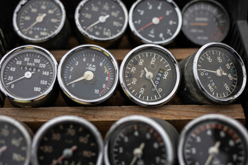 Many old motorcycle speedometer  in row