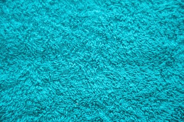 Blue material of pile texture of the carpet. Fabric for indoor floor decoration.