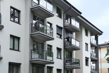 Exterior of white and black building with glass balconies