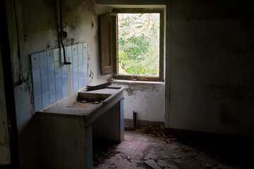 Remnant of a kitchen sink in the ruin of a abandoned house