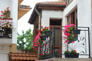 Fototapeta na wymiar Exterior of beautiful residential building with balcony and flowers