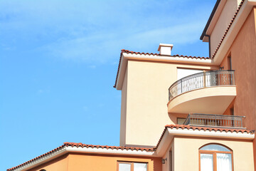 Fototapeta na wymiar Exterior of beautiful residential buildings with balconies against blue sky
