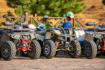 ATVs in the parking lot are rented in the recreation area. Quad bike and equipment. Extreme Entertainment. Kazakhstan, Shymkent - October 17, 2022 © Vera