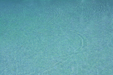 Fototapeta na wymiar Calm clear water in swimming pool outdoors