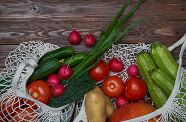 Healthy food vegetables in Eco-friendly packaging reusable bag on wooden table background.