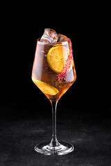 Whiskey splash cocktail with lemon and ice. Vertical