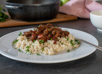 Beef stew with brown rice on a plate