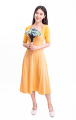 A woman in a yellow dress with a bunch of flowers