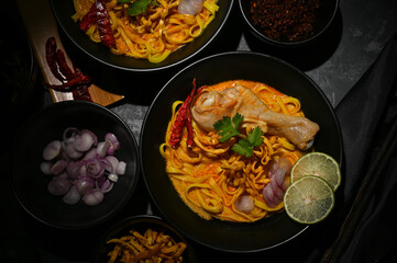 Delicious and tasty spicy creamy curry soup with chicken and egg noodles or Khao Soi Kai.