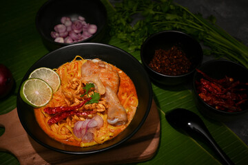 A bowl of Northern Thai chicken curry with egg noodles with vegetables or Khao Soi Kai