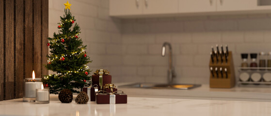 Luxury white marble kitchen tabletop with Christmas tree, candles, gifts and copy space