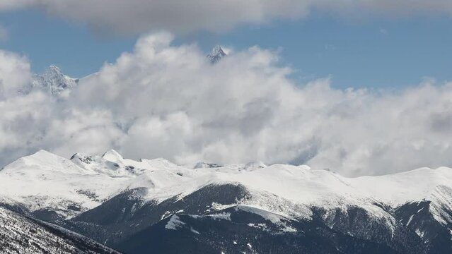 Time lapse of clouds in motion over the snow-covered Nanga Baba peak in Tibet