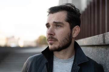 Fototapeta premium depressed man looks away with despair, concept of poor mental state thoughts of suicide