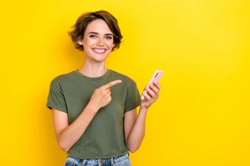 Photo of positive satisfied girl with bob hairstyle wear khaki t-shirt directing at smartphone...