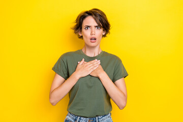 Portrait of negative unhappy woman with bob hairdo dressed khaki t-shirt hands on chest blaming...