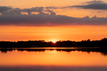 Fototapeta na wymiar Clouds reflections and beautiful colors of a tranquil sunset at North Turtle Lake in Minnesota 