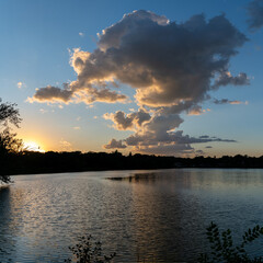 Clouds reflections and beautiful colors of a tranquil sunset at Lake Alice in Fergus Falls, Minnesota USA
