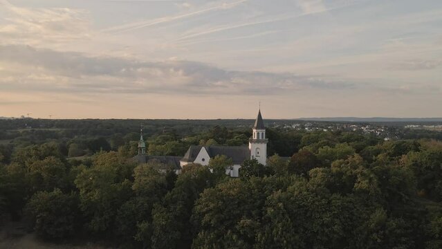 Zoom out drone shot of the Kreuzberg church in city of Bonn, Germany