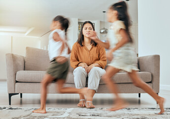 Child care stress, mother and children running with energy with mom feeling anxiety on a home sofa....