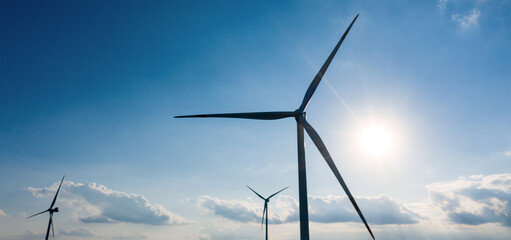 a modern wind turbine park panorama in front of a blue sky © Tobias Arhelger
