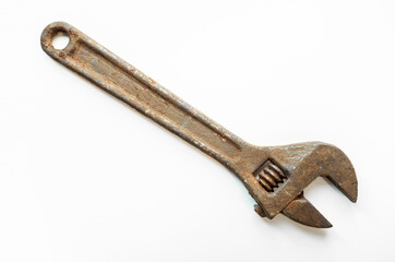 A large rusty wrench on a white background. An old tool for unscrewing nuts.Unscrew the bolt.