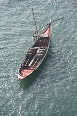 Fototapeta premium A boat carries wine on Douro river in Oporto, Portugal
