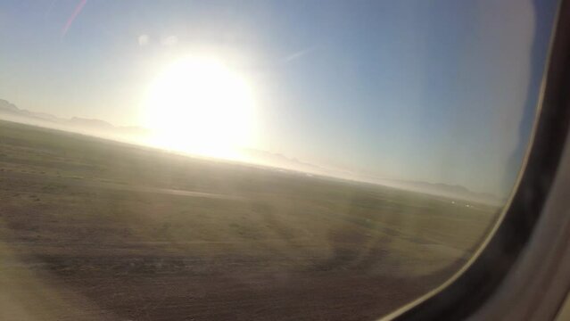 Airplane departing, Taking off into the sky in South Africa with a beautiful sunrise.