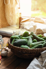 Fresh cucumbers and other ingredients on wooden table, closeup. Pickling vegetables