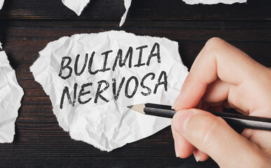 Bulimia nervosa is an eating disorder. Pencil writing on a piece of paper. - obrazy, fototapety, plakaty