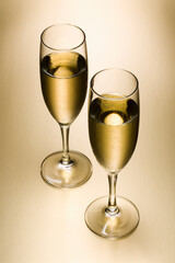 two champagne glasses filled with champagne