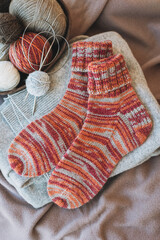 Hand knitted socks with needles and yarn ball. Concept for handmade and hygge slow life.