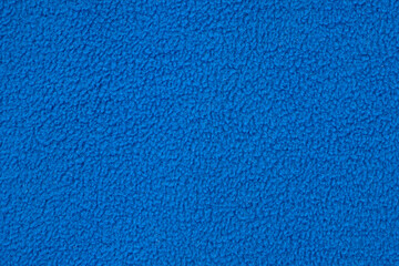 Blue fleece jacket lining as texture or background, top view.