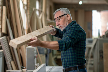 Carpenter working with wood in a workshop