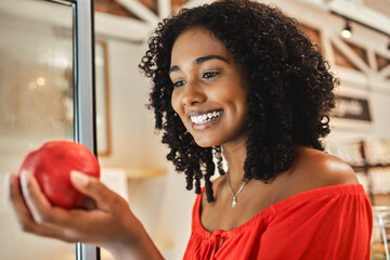 Supermarket, shopping and black woman with quality apple check, healthy food price and discount for commerce, retail and supply chain industry. Happy woman in grocery store with fruits for nutrition