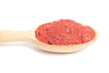 natural tomato paste in wooden spoon isolated on white