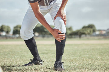 Baseball leg injury, man and sports athlete on a outdoor grass field hurt in the summer. Baseball player experience a muscle pain from workout exercise, fitness and cardio game training accident