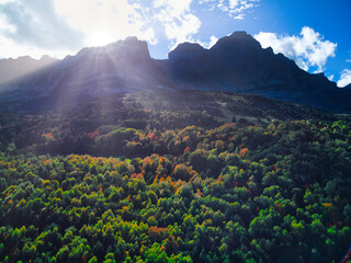 Silhouette of the mountain and autumn forest towards the lake of Piedrafita de Jaca in the...